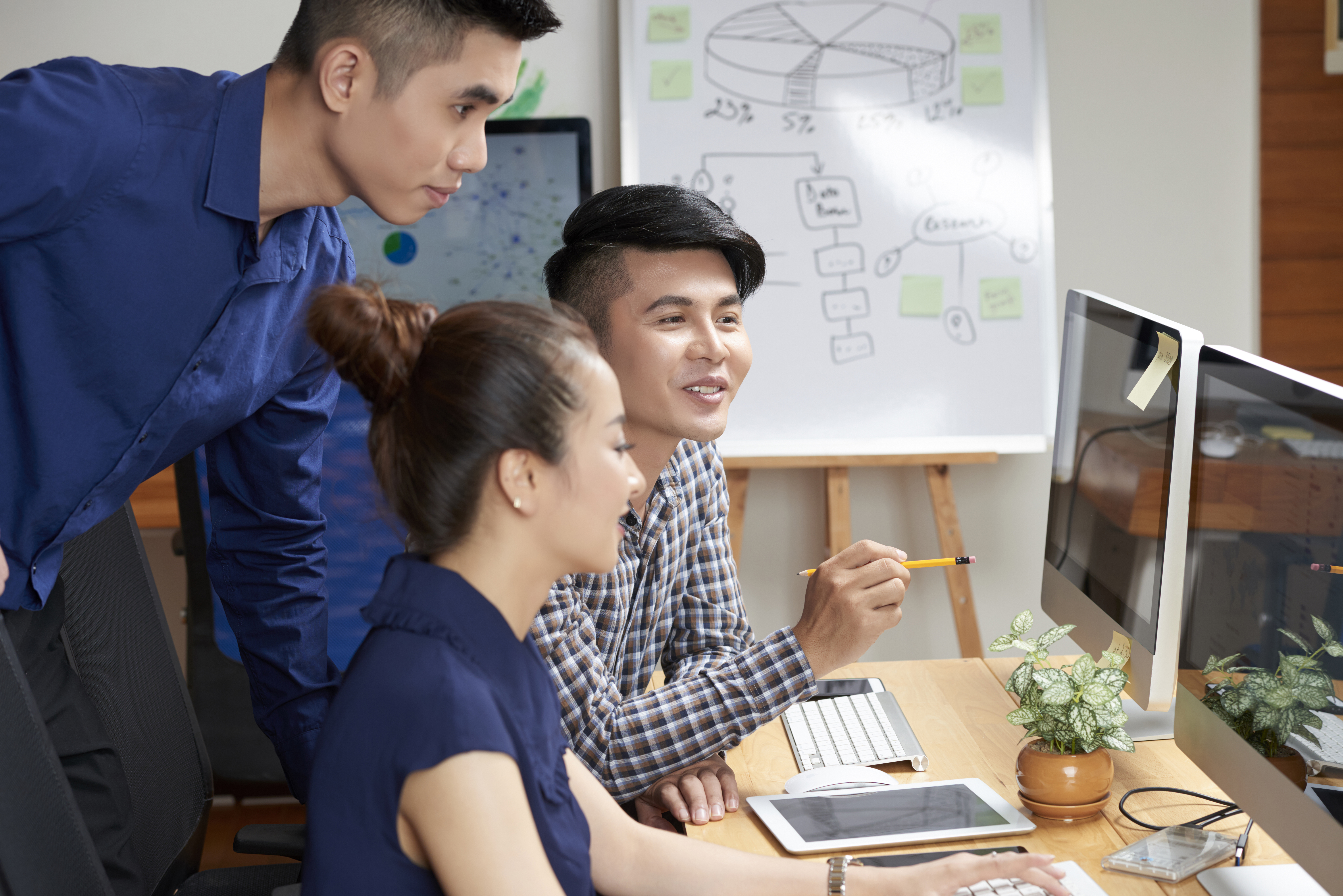 Group of developers working on a web development project, collaborating on code and design | Scope88